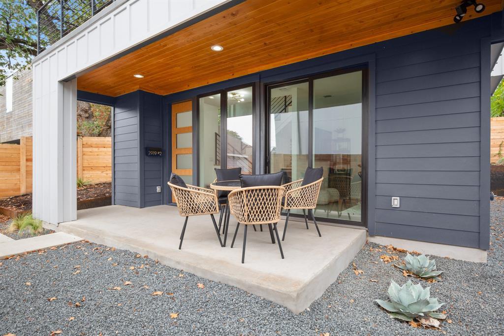 2919 East 13th Street, Unit 2 Austin, TX 78702 - Photo 3 of 20 a view of a patio with table and chairs and potted plants