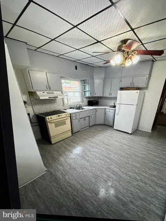 a kitchen with stainless steel appliances granite countertop a sink and cabinets