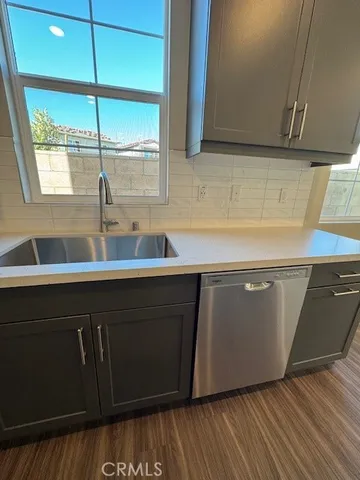 a kitchen with a sink and wooden cabinets