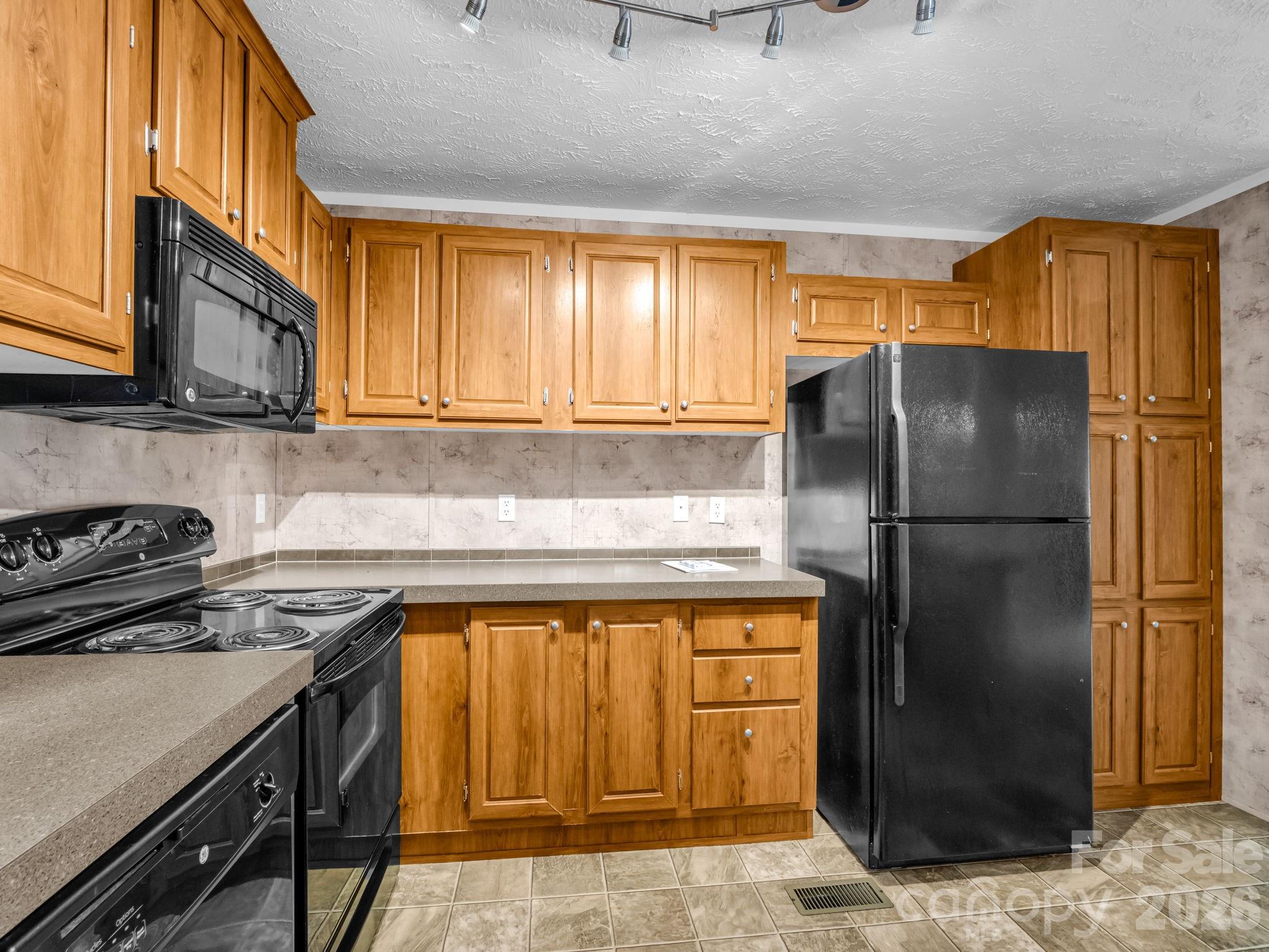 1449 Toney Road Bostic, NC 28018 - Photo 21 of 43 a kitchen with a refrigerator and a stove top oven