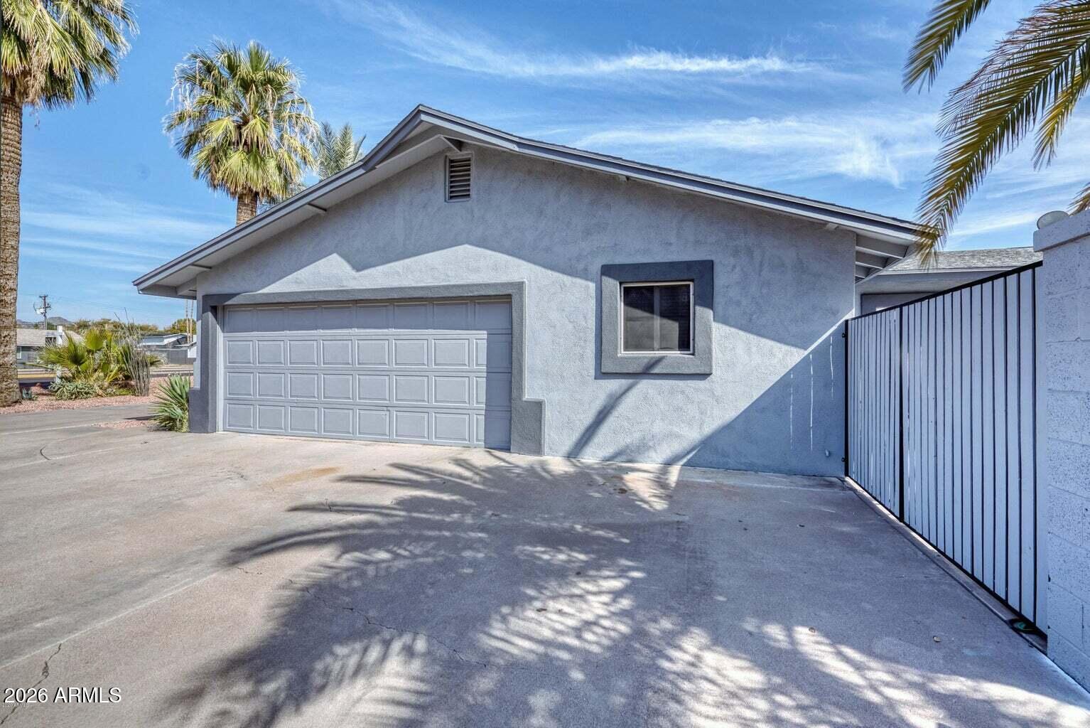 3415 East Camelback Road Phoenix, AZ 85018 - Photo 24 of 25 a front view of a house with a yard and garage