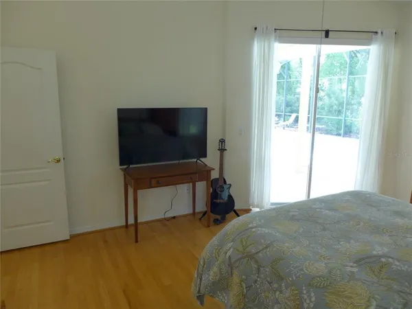 a bedroom with a bed and a flat screen tv
