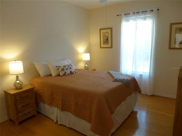 a bedroom with a bed and a lamp