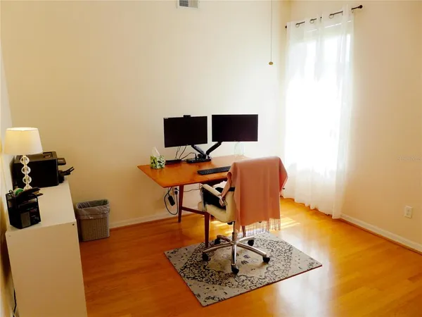 a work room with furniture and a rug
