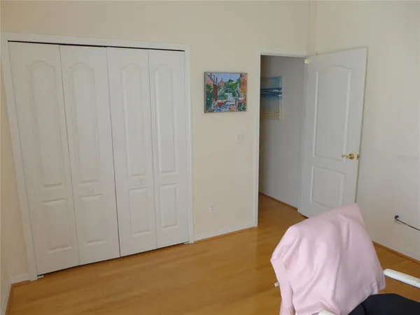 a bedroom with a bed and a plant