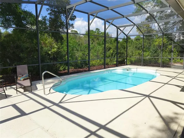 a patio with yard glass top table and chairs