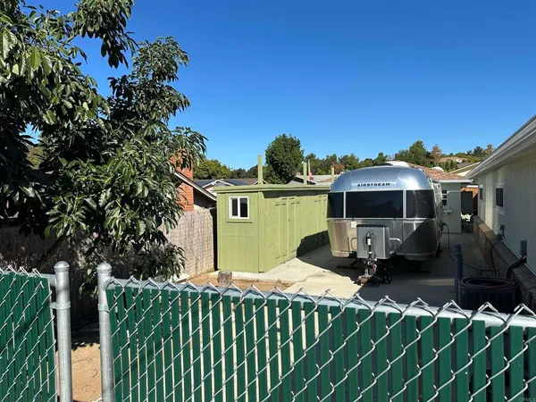 a view of a back yard of the house with a street