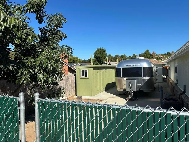 a view of a back yard of the house with a street