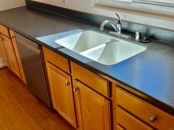 a kitchen with stainless steel appliances a stove a microwave oven cabinets and wooden floor