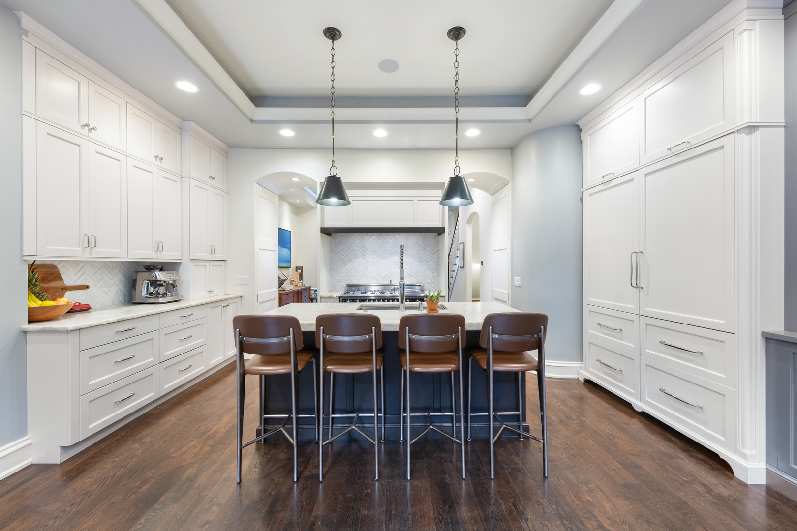 41 East Elm Street Chicago, IL 60611 - Photo 13 of 50 a kitchen with stainless steel appliances kitchen island granite countertop a table chairs and wooden floors