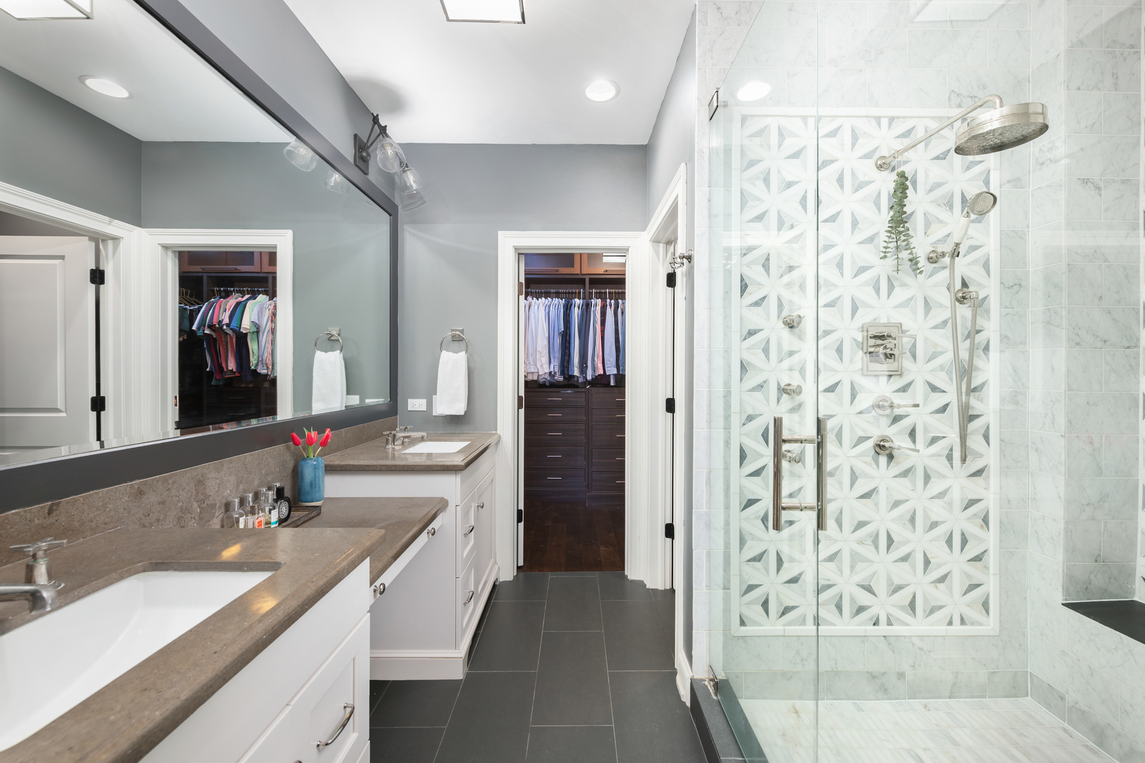 41 East Elm Street Chicago, IL 60611 - Photo 23 of 50 a bathroom with a double vanity sink a toilet a shower and a mirror