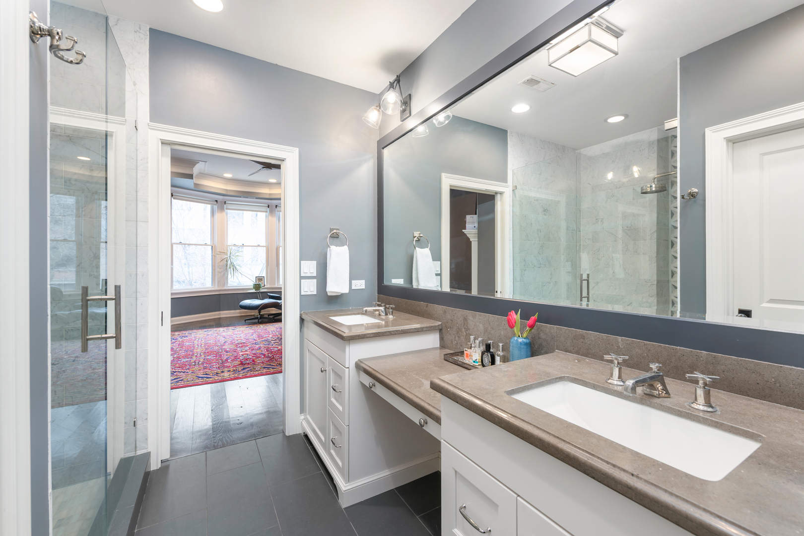 41 East Elm Street Chicago, IL 60611 - Photo 25 of 50 a en suite bathroom with a granite countertop sink and a mirror