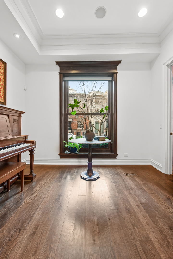 41 East Elm Street Chicago, IL 60611 - Photo 4 of 50 a view of an empty room with wooden floor and a window