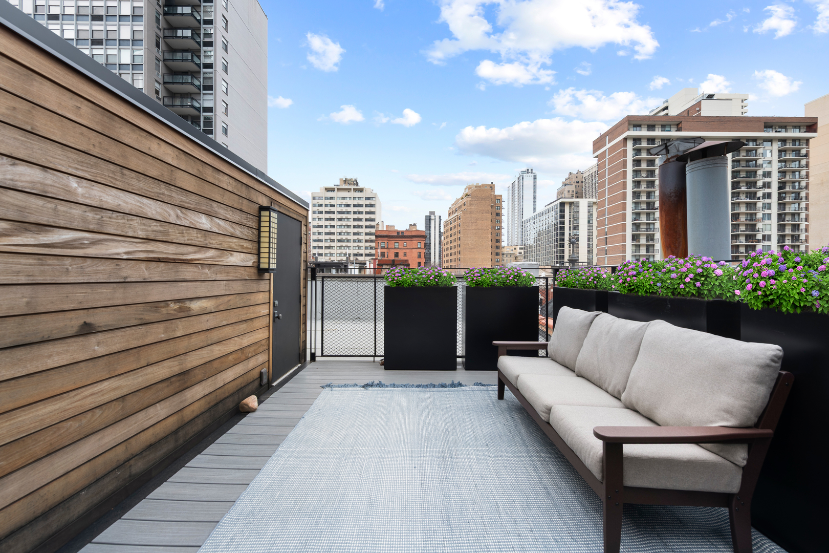 41 East Elm Street Chicago, IL 60611 - Photo 41 of 50 a view of a terrace with couches and wooden floor