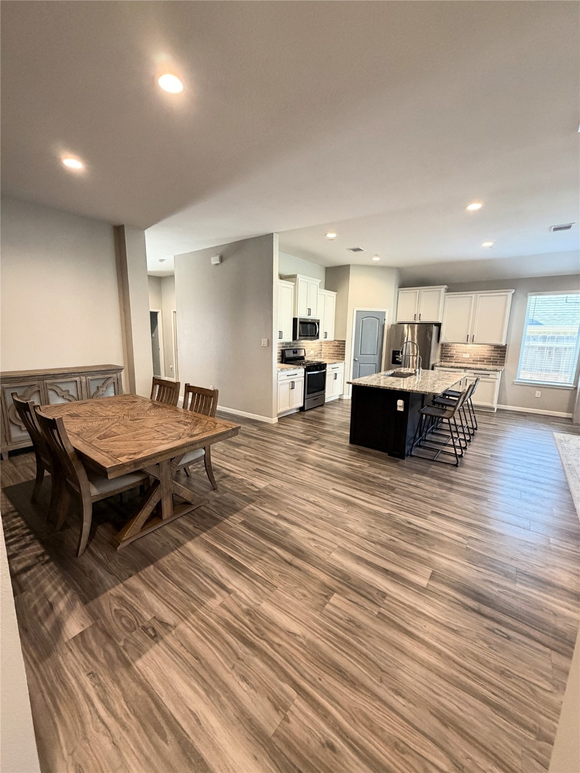 443 Stonebrook Lane Conroe, TX 77304 - Photo 4 of 21 Vinyl Plank flooring with Gorgeous Granite large living area for easy entertaining family and friends.