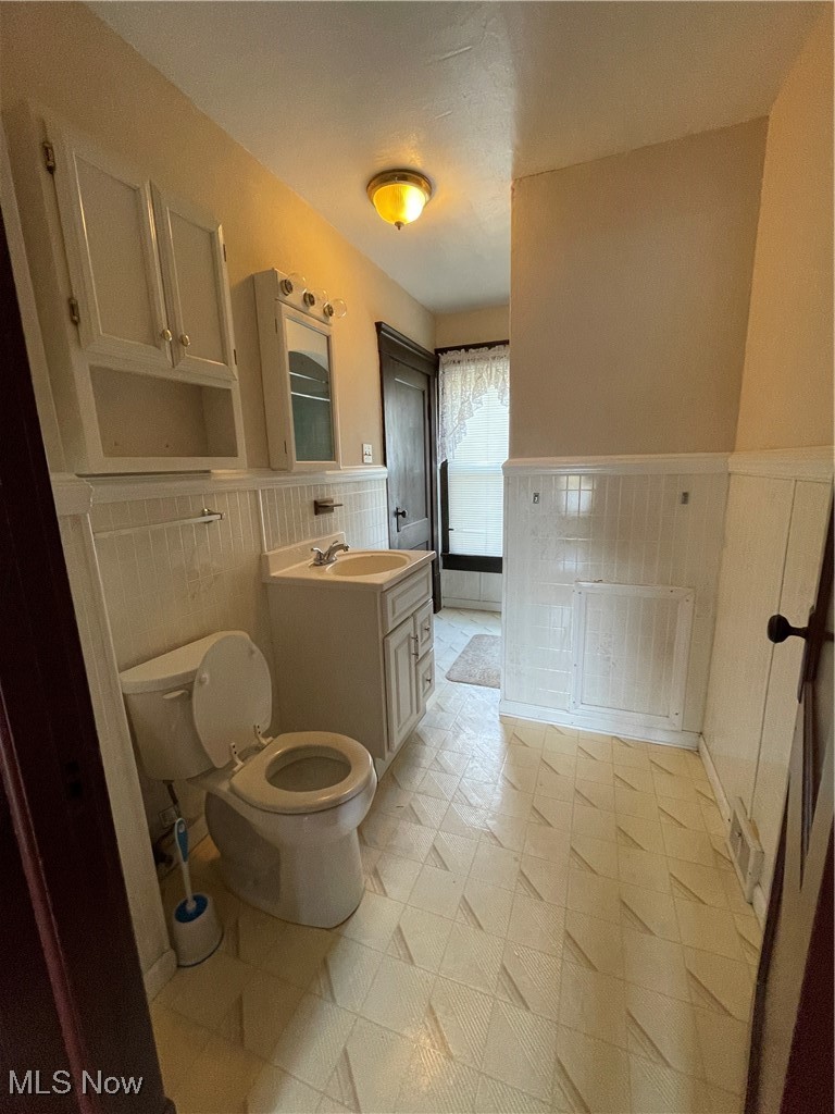 1881 Manchester Road Akron, OH 44314 - Photo 23 of 31 Bathroom with wainscoting and vanity