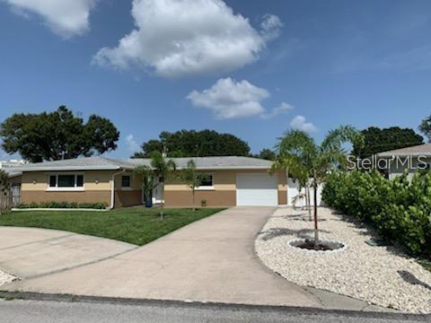 527 Eastview Road Largo, FL 33770 - Photo 1 of 14 a front view of a house with garden