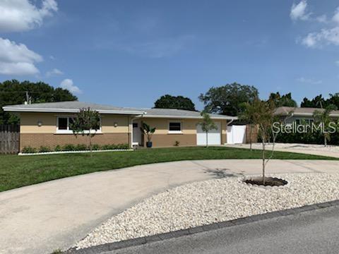 527 Eastview Road Largo, FL 33770 - Photo 14 of 14 a front view of a house with a yard and garage