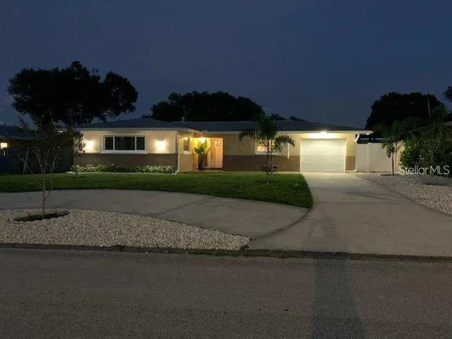 a front view of a house with a yard and a garage