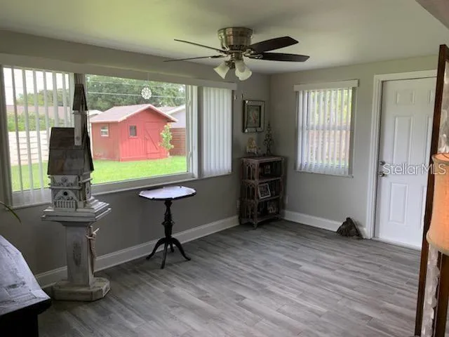 a view of a dining room with furniture window and wooden floor