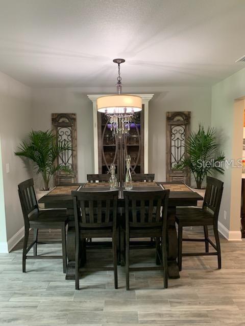 527 Eastview Road Largo, FL 33770 - Photo 5 of 14 a view of a dining room with furniture window and wooden floor