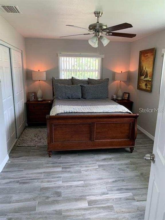 527 Eastview Road Largo, FL 33770 - Photo 7 of 14 a spacious bedroom with a bed and a chandelier