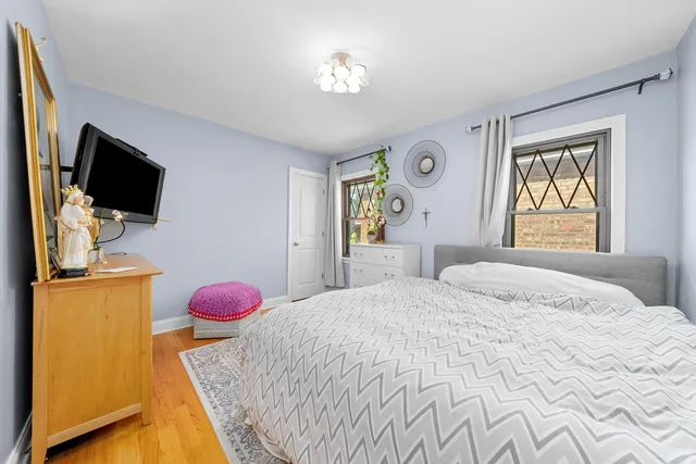 a bedroom with a bed and flat screen tv