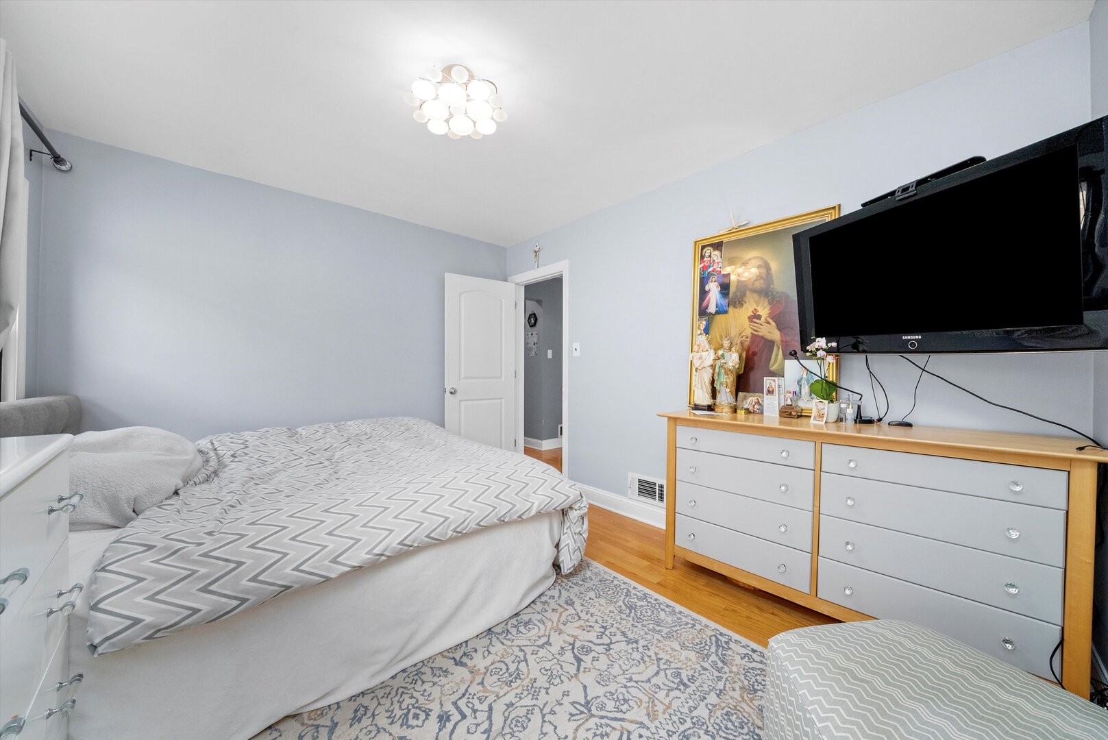 5009 South Kostner Avenue Chicago, IL 60632 - Photo 13 of 41 a bedroom with a bed and a flat screen tv