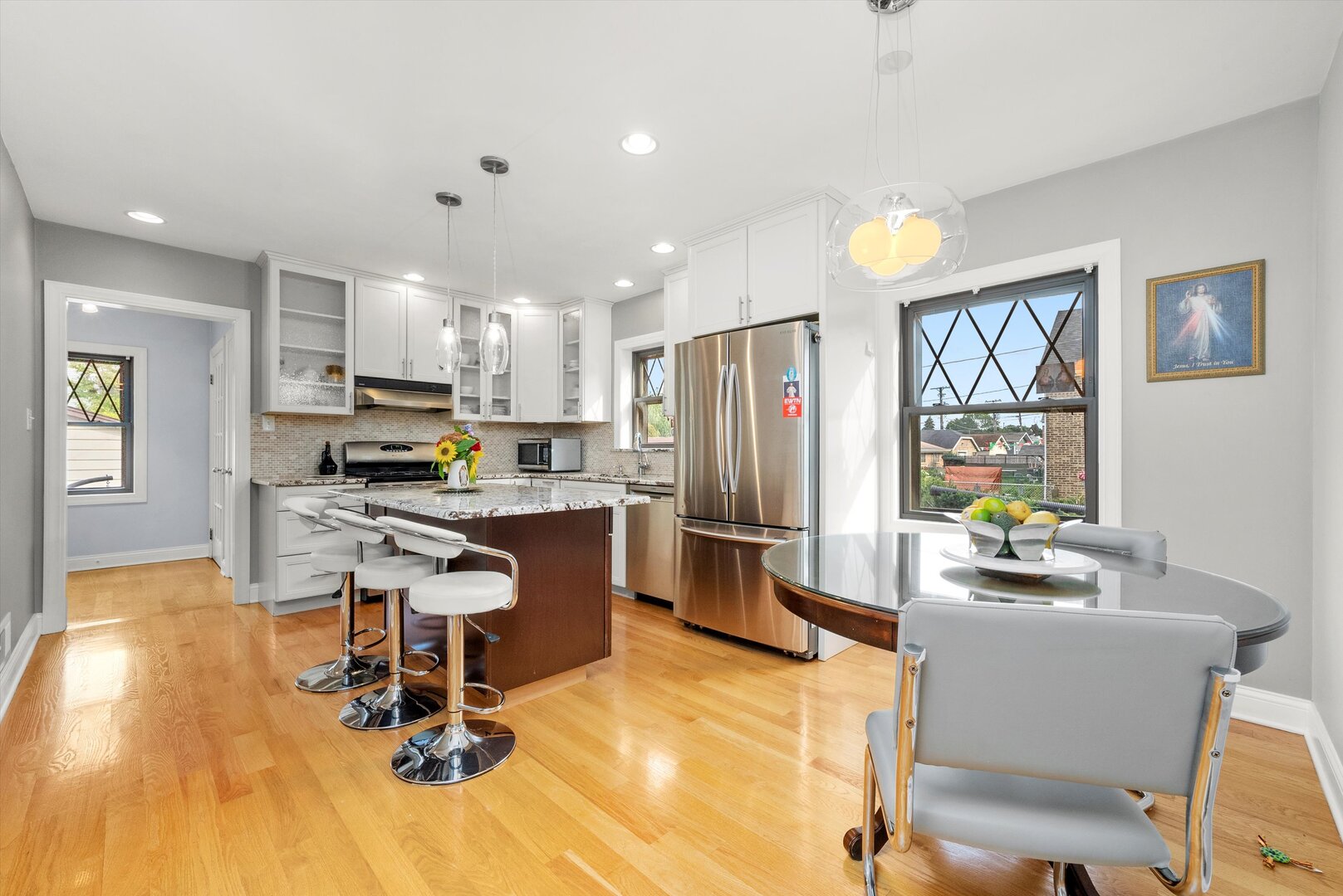 5009 South Kostner Avenue Chicago, IL 60632 - Photo 16 of 41 a kitchen with a refrigerator a stove a sink dishwasher and a dining table with wooden floor