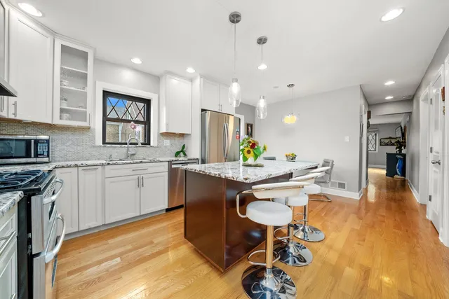 a kitchen with white cabinets and counter space