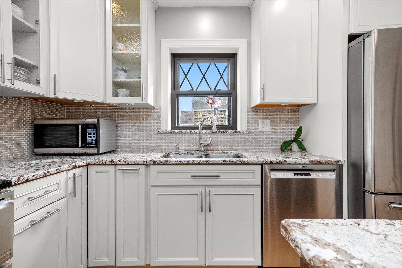 5009 South Kostner Avenue Chicago, IL 60632 - Photo 20 of 41 a kitchen with granite countertop white cabinets and stainless steel appliances