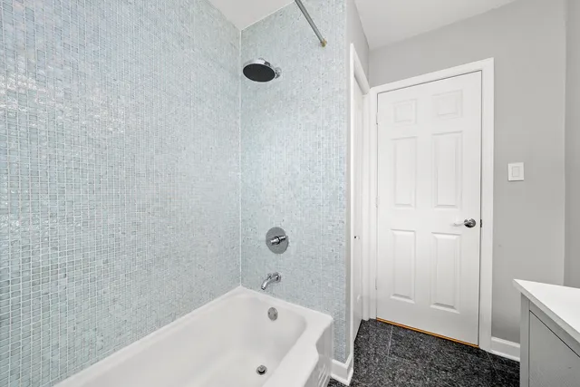 a bathroom with a tub and shower