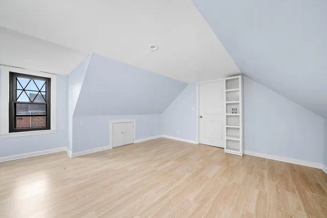 an empty room with windows and closet