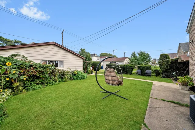 a white house with a yard and plants