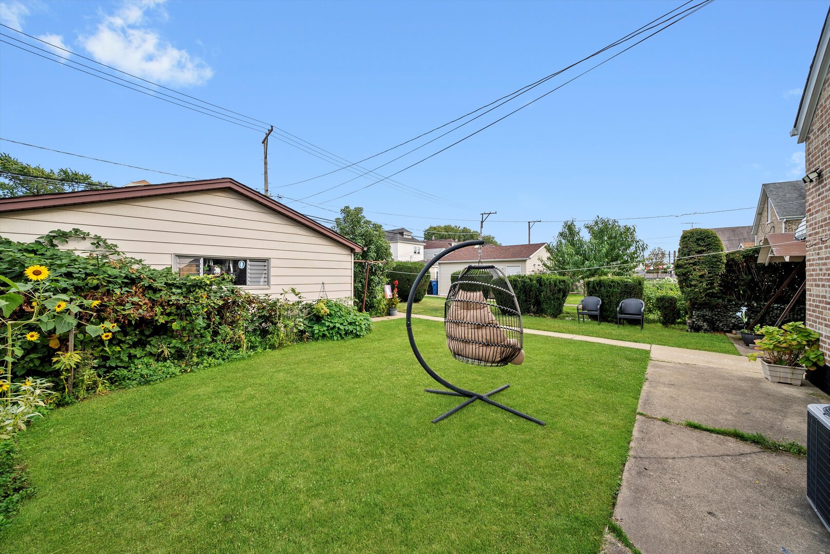 5009 South Kostner Avenue Chicago, IL 60632 - Photo 39 of 41 a white house with a yard and plants