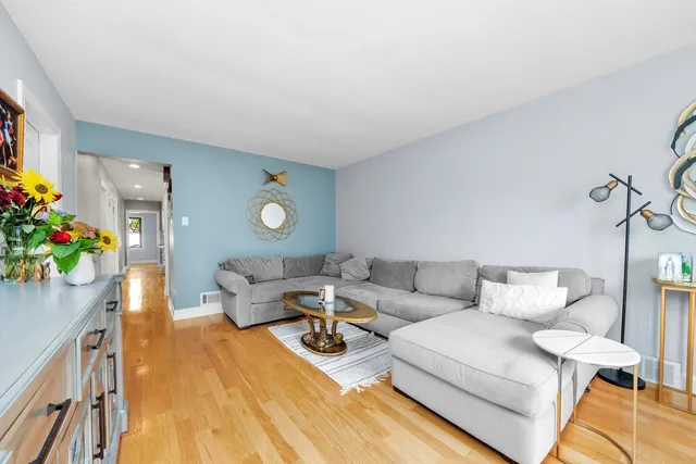 a living room with furniture and flowers