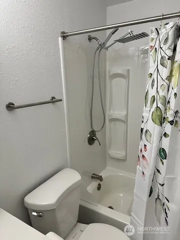 a kitchen with granite countertop white cabinets and a stainless steel appliances