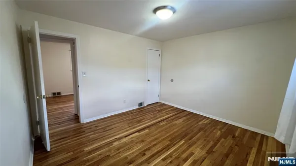 a view of room with wooden floor