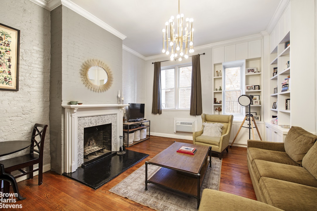 103 East 10th Street, Unit 3C Manhattan, NY 10003 - Photo 2 of 7 a living room with furniture fireplace and window