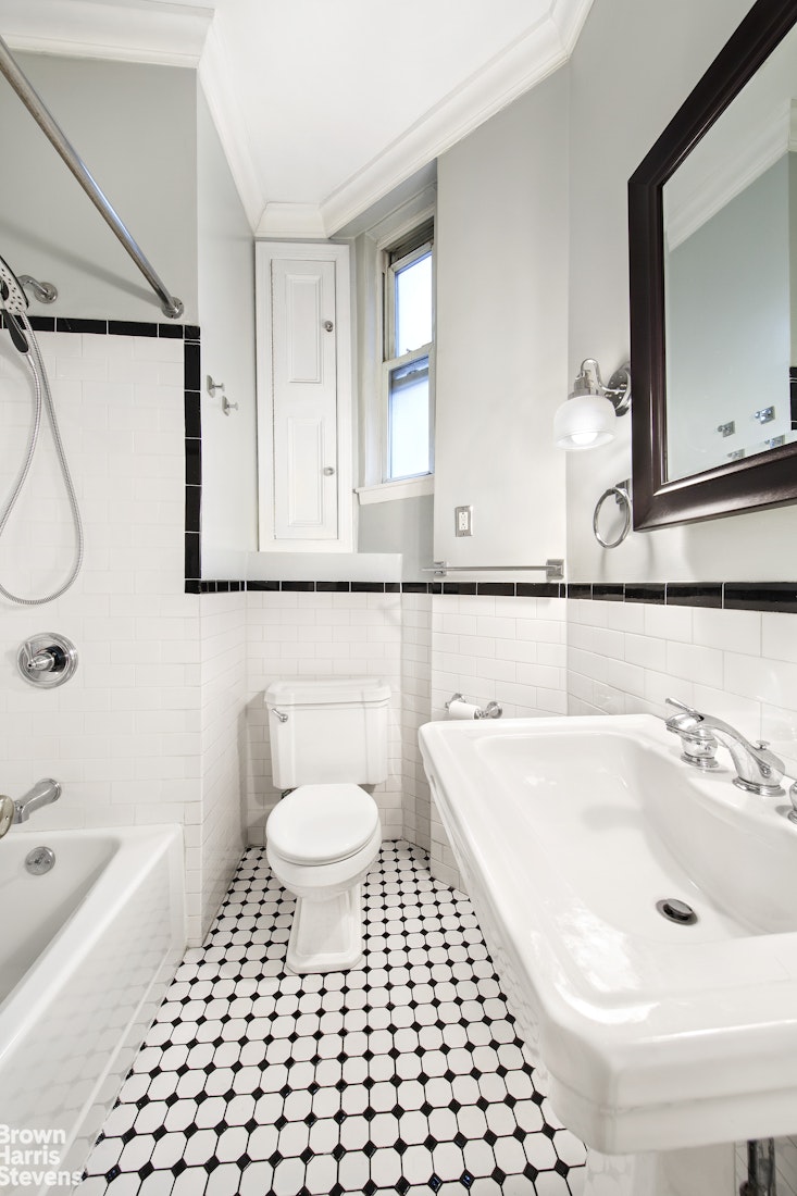 103 East 10th Street, Unit 3C Manhattan, NY 10003 - Photo 5 of 7 a bathroom with a sink a toilet and a mirror