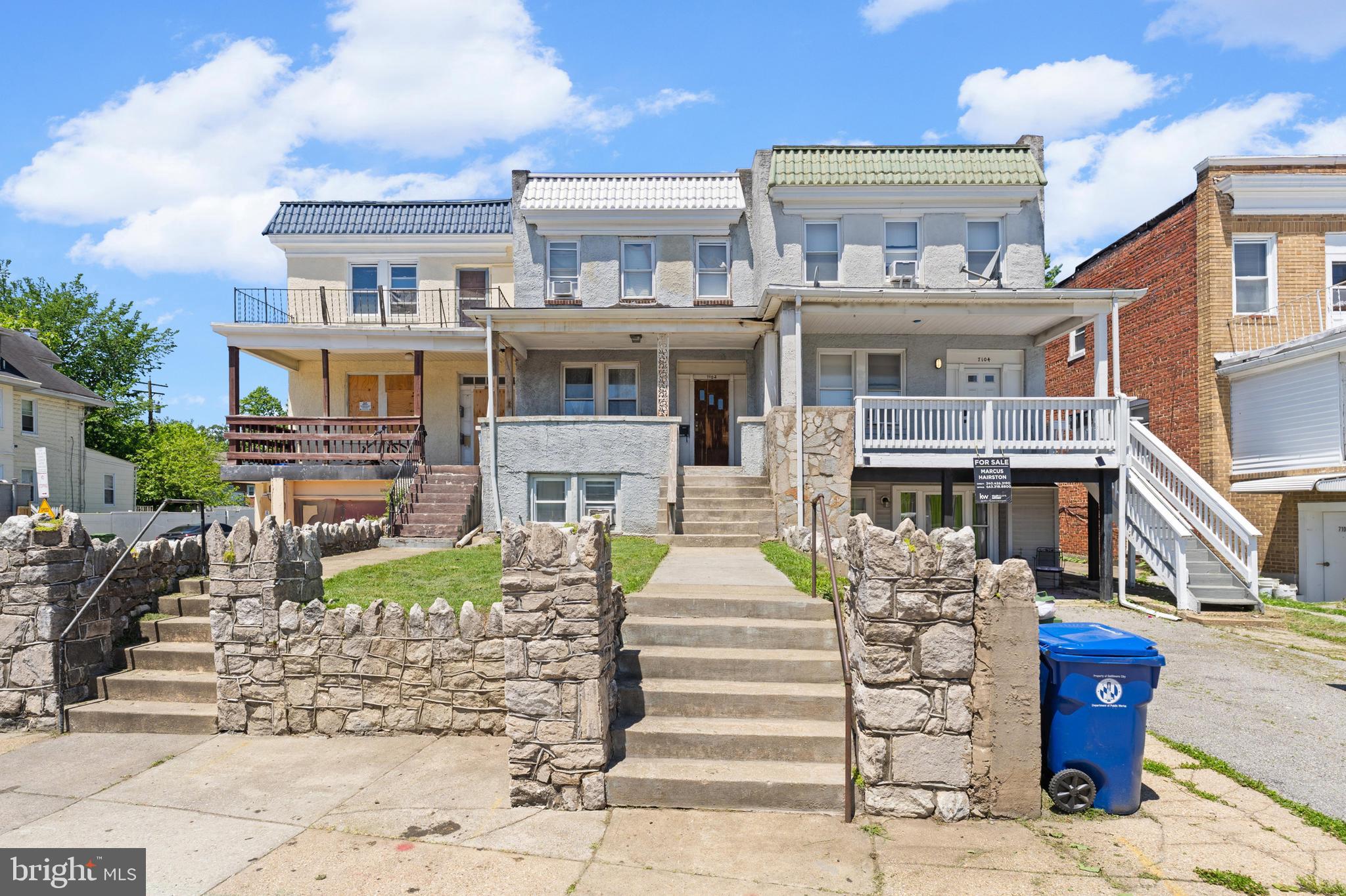 a front view of a residential apartment building with a yard