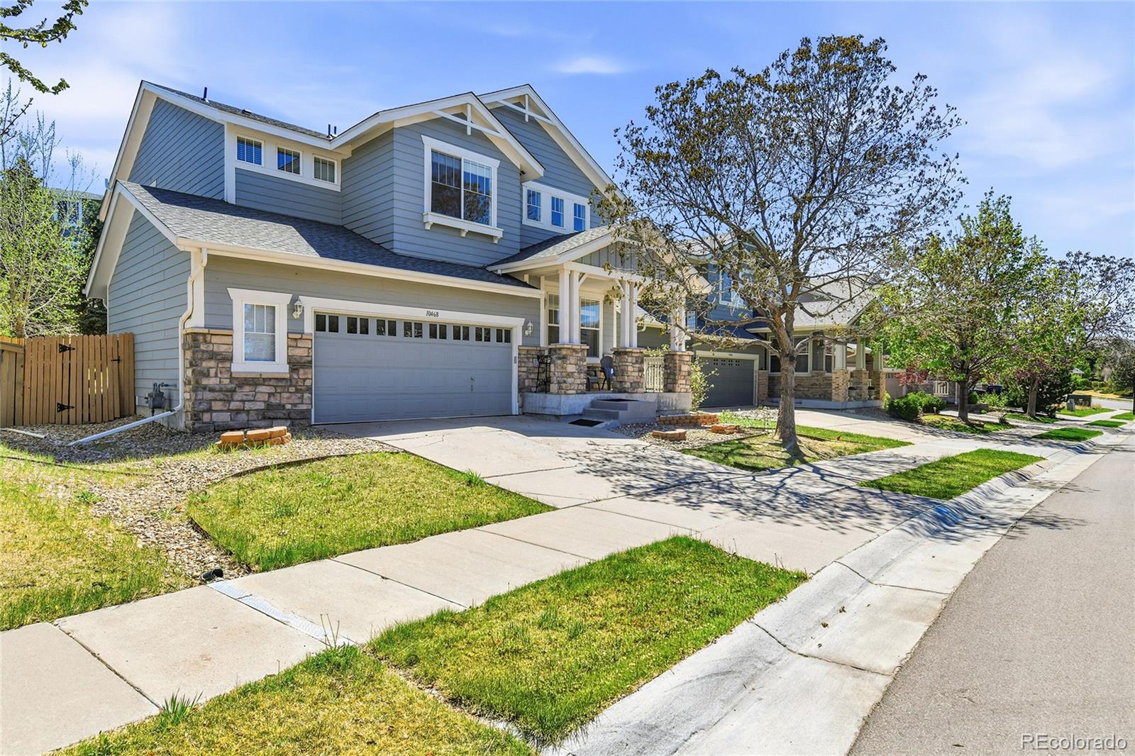10468 Wagon Highlands Ranch Littleton, CO 80130 - Photo 2 of 48 a front view of a house with a yard and garage
