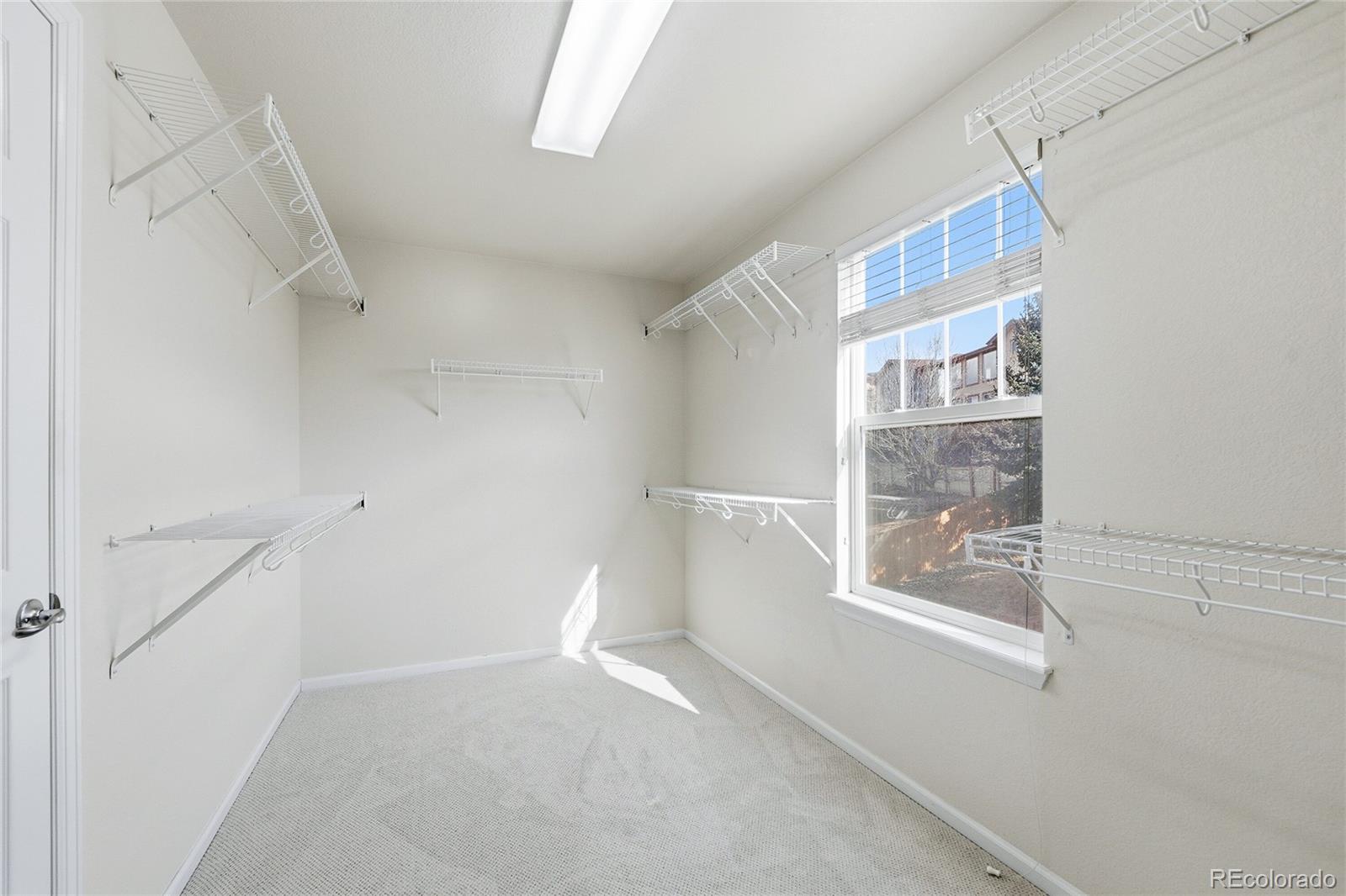 10468 Wagon Highlands Ranch Littleton, CO 80130 - Photo 24 of 48 a view of small space with racks on the wall
