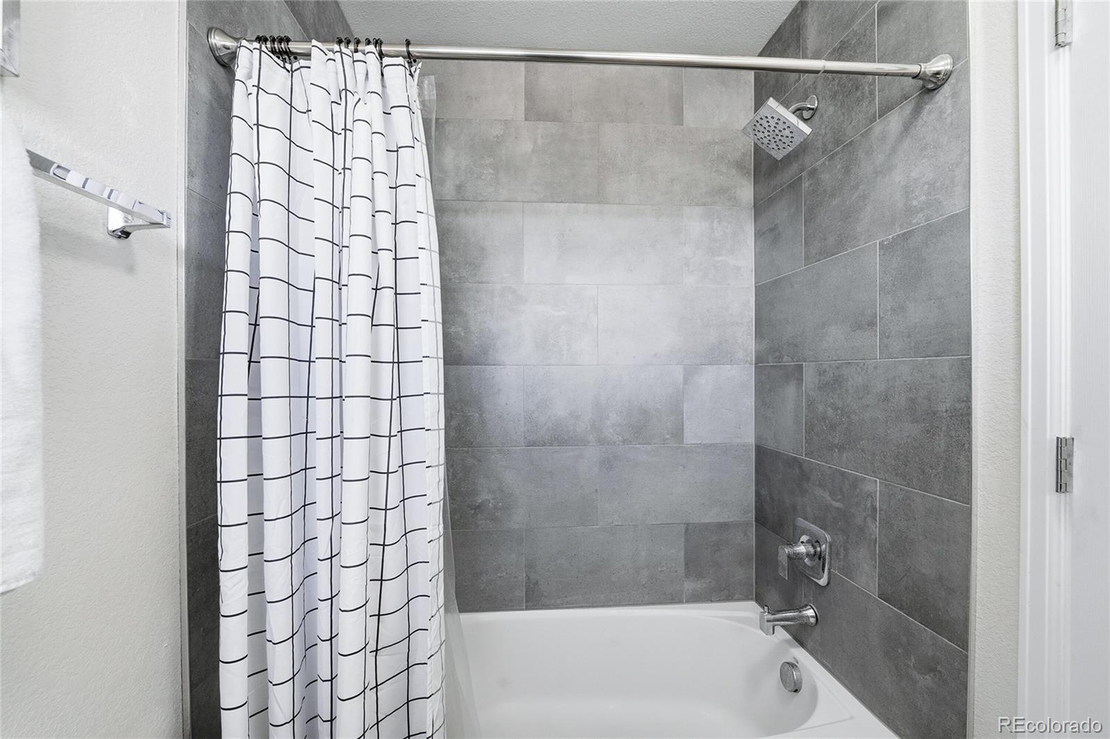 10468 Wagon Highlands Ranch Littleton, CO 80130 - Photo 29 of 48 a bathroom with a shower and a bathtub