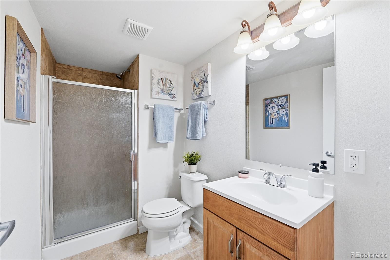 10468 Wagon Highlands Ranch Littleton, CO 80130 - Photo 36 of 48 a bathroom with a sink a toilet and shower