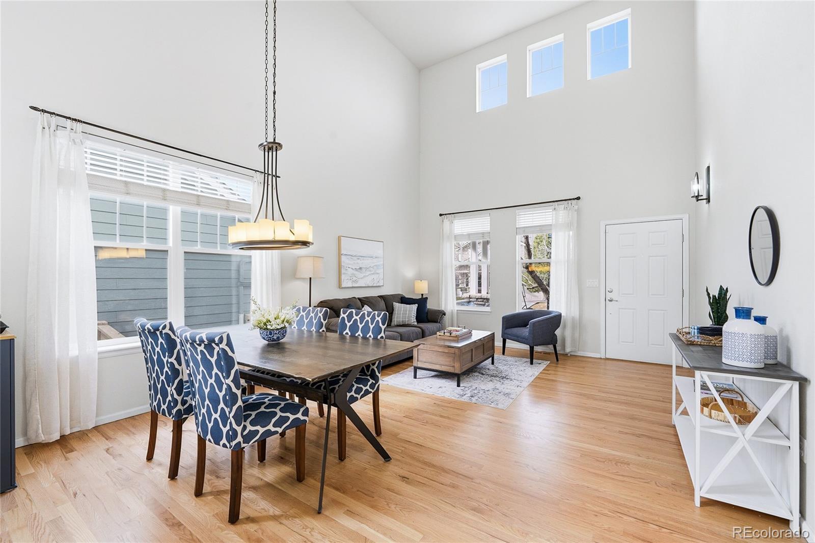 10468 Wagon Highlands Ranch Littleton, CO 80130 - Photo 5 of 48 a view of a dining room with furniture and wooden floor