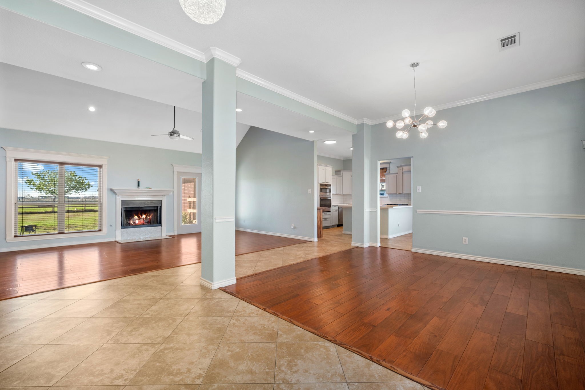 7740 Farm To Market 1462 Rosharon, TX 77583 - Photo 4 of 35 an empty room with fireplace chandelier and windows