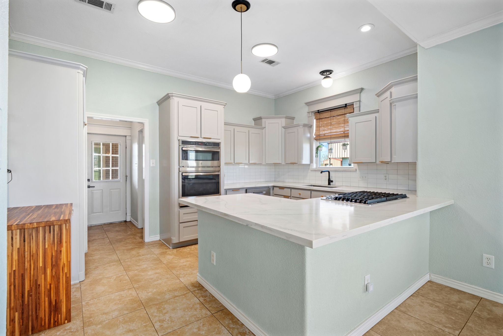 7740 Farm To Market 1462 Rosharon, TX 77583 - Photo 9 of 35 a kitchen with stainless steel appliances granite countertop a stove refrigerator sink and cabinets