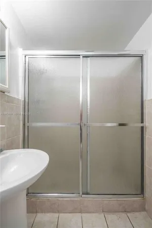 a bathroom with a shower and a sink