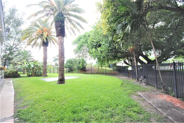 a backyard of a house with palm trees